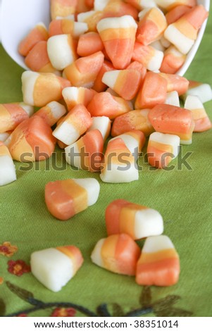 Spilled candy corn on green background