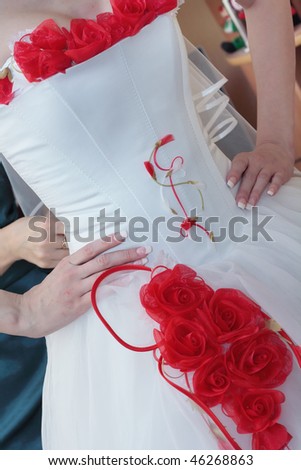 stock photo Wedding Dress with a decoration of red roses on the bride