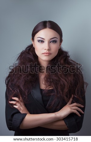 Beautiful woman with luxury make-up in fashionable dark suite.