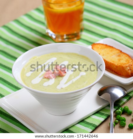 Single soup and bread in dish on the table.