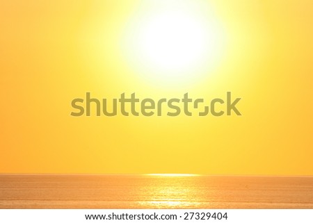 sunrise,large white sun,yellow sky and ocean