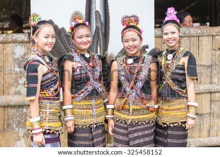 Tambunan, Malaysia - May 1, 2015: Girls of various Rungus ethnic in their traditional costume pose for the camera during the Sabah State Harvest festival celeberation in Tambunan, Sabah.