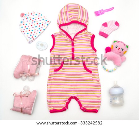 top view of baby girl clothes and toy stuff, baby fashion concept