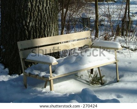 bench buried under pile of snow