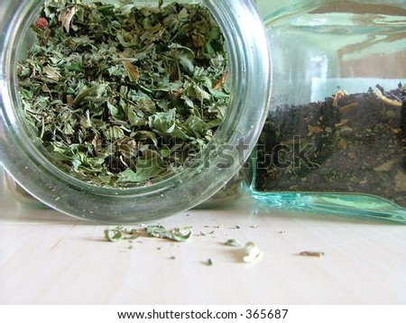 green tea spilling out from a glass jar