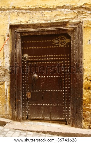 Old ancient door to a arabic home. Medina (old town) of Fes, Morocco.