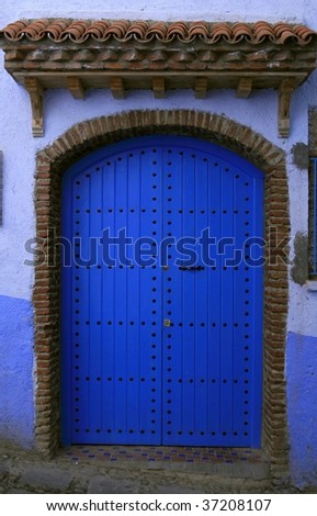 Bright blue house door in the city of Chefchaouen, Morocco