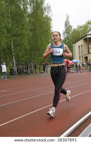 TARTU, ESTONIA - MAY 20: Athlete running along the track and taking part in Student Sell Games, organized by Estonian Academic Sports Federation in May 20, 2006