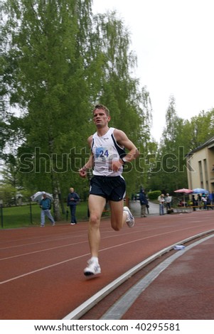 TARTU, ESTONIA - MAY 20: Athlete running along the track and taking part in Student Sell Games, organized by Estonian Academic Sports Federation in May 20, 2006 in Tartu, Estonia.