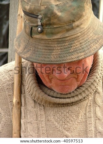Old man with a hat and a walking stick