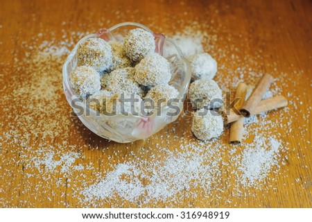 Coconut candies. Some Coconut Pralines (close-up shot) on wooden background.