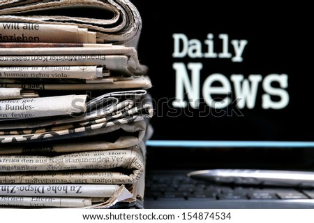 Stack of newspapers beside the lettering Daily News