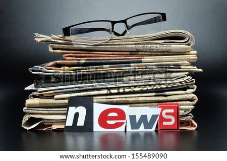 Stack Of Newspapers With Glasses On Top