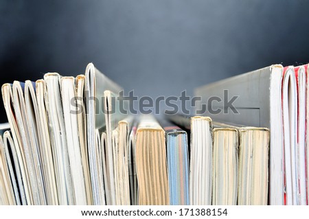 Row of magazines in front of black background