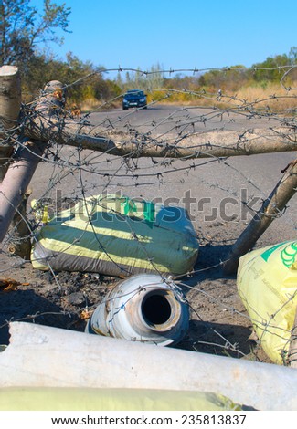 ILOVAYSK, DONBASS, OCT 9: GRAD missile stuck in the road in Ilovaysk on 9 October 2014. Road sign showing how much kilometers left to Donestk and Khartsyzk.