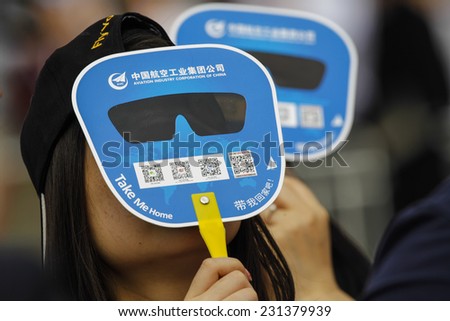ZHUHAI, CHINA - NOV. 11. 2014:Spectator looking to sky for airplanes on Airshow China 2014 in Zhuhai, Guangdong province.