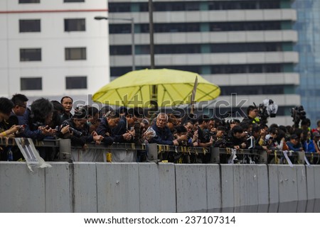 HONG KONG, DEC. 11. 2014: People observe workers remove barricades at an area blocked by pro-democracy protesters near the PLA headquarters, as today is the last day of the protest.