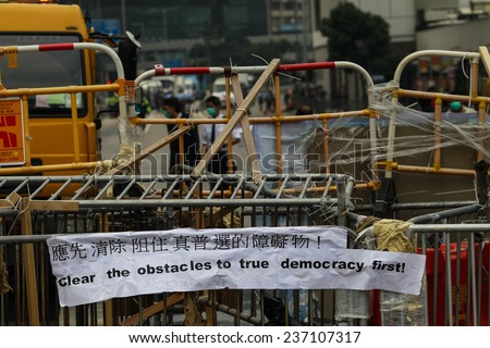 HONG KONG, DEC. 11. 2014: Workers and police remove barricades at an area blocked by pro-democracy protesters near the PLA headquarters, as today is the last day of the protest.