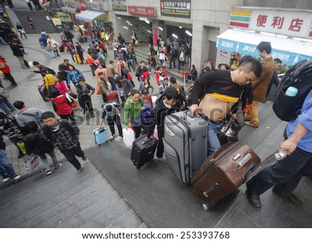 GUANGZHOU, CHINA - FEB. 14. 2015: people carries luggage on Gunagzhou Main Railway Station plateau in Guangzhou, Guangdong province.