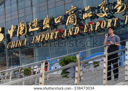 GUANGZHOU, CHINA - OCT 17. 2015:A man talks on his phone in front of China Import And Export Fair also known as Canton Fair. The Canton Fair is the largest trade fair in China.