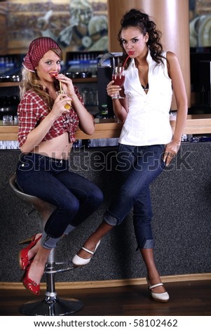 sexy pin-up girls drinking cocktails in the bar
