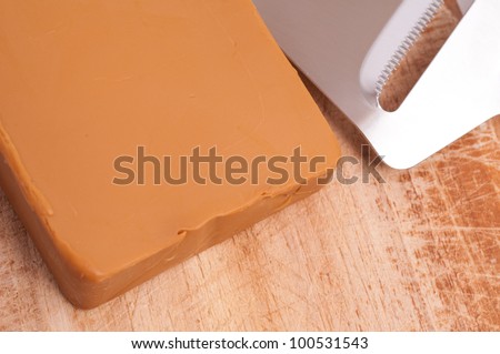 Close-up of a norwegian Gudbrandsdalen cheese with slicer
