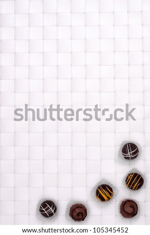 Brown sweets on a white squared background
