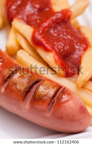Roasted smoked polish sausage with chips and ketchup