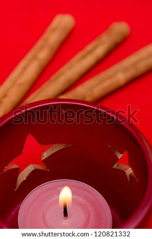 Candle and stars with cinnamon sticks