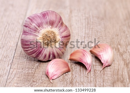 Garlic with three cloves on weahtered wood