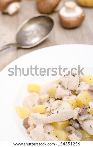 Blanquette from turkey with potatoes in a white plate