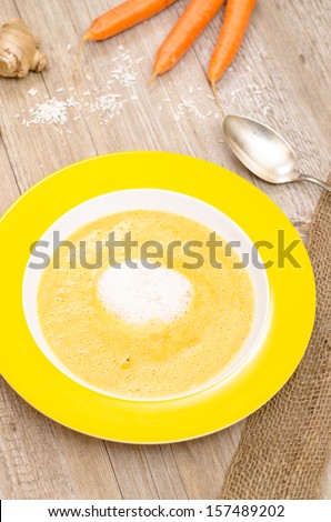 Carrot cream soup with ginger in vertical format