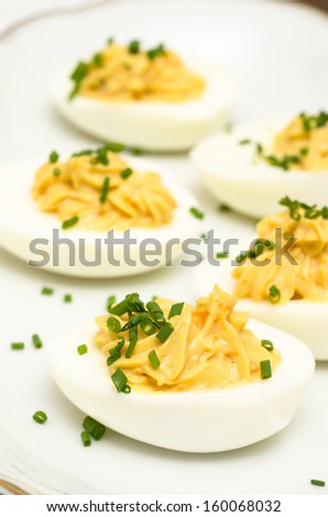 Hard boiled eggs with yolk filling and chives