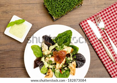 Leaf salad with roasted turkey filet, serrano ham and green basil sauce