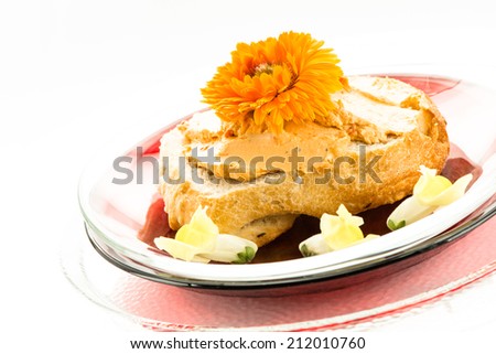 Roll with tomato cream cheese and edible flower