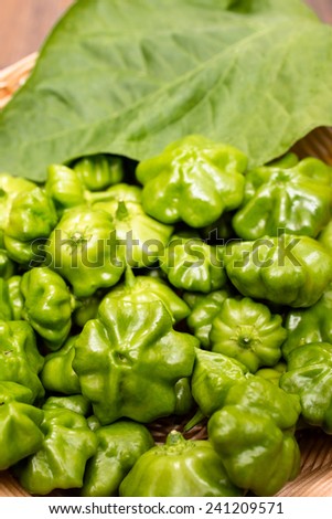 Green chili pepper with leaf in vertical format