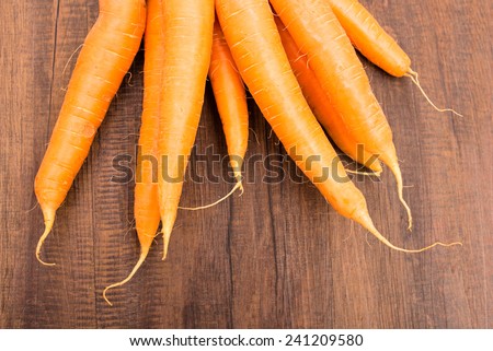 Close up root vegetable carrots on a wooden board