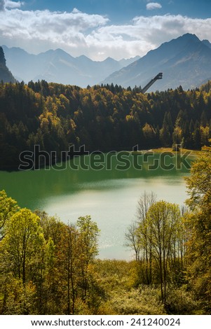 Ski jump with forest, lake and mountains in fall