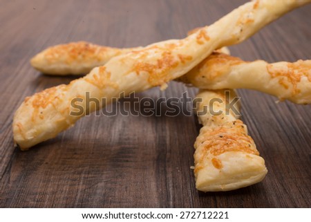 Cheese sticks with flaky pastry, parmesan cheese an pepper