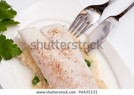Filet from cod with mashed celery and paisley and a fish knife and fork