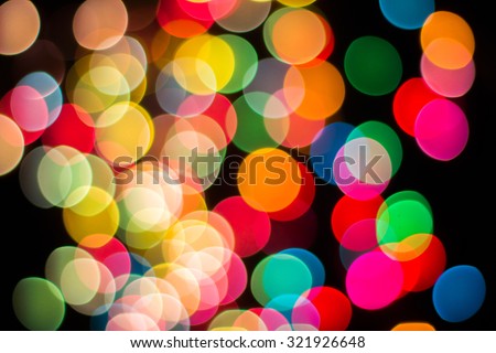 Texture of bokeh and blur from colorful light in dark background.