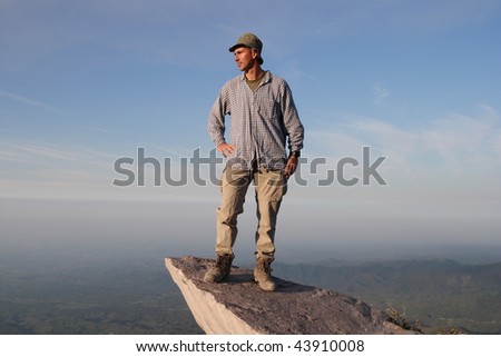Looking far in the future.   The photographer with self portrait on a rock in the Guatemala Highland. Volcano Santa Maria  view to the pacific coast