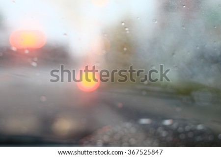 Silhouette edge The rain is falling. Bokeh on the road in the morning. In Thailand.Abstract blurred background : Traffic jam in the morning rush hour. in-Thailand.