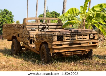 Old wooden car in the jungle . Thailand .