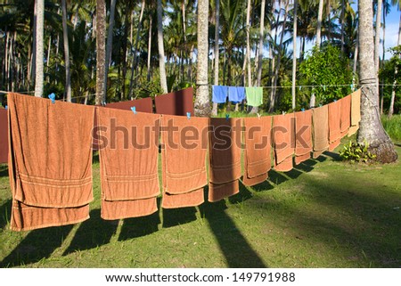 Fresh clean hotel towels drying on a line outdoors