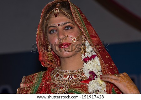 PUSHKAR, INDIA - NOVEMBER 23: An unidentified girl participate in the competition of Indian fashion on November 23, 2012 in Pushkar, Rajasthan, India. Portrait girl in colorful ethnic attire.
