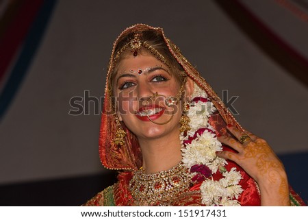 PUSHKAR, INDIA - NOVEMBER 23: An unidentified girl participate in the competition of Indian fashion on November 23, 2012 in Pushkar, Rajasthan, India. Portrait girl in colorful ethnic attire.
