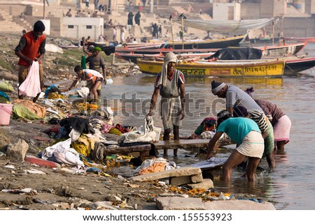 VARANASI, INDIA - DECEMBER 1: Unidentified Indian people wash clothes in Ganga river on  December 1, 2012 in Varanasi, India. For many dwellers of Varanasi the Ganga is only way to wash clothes.