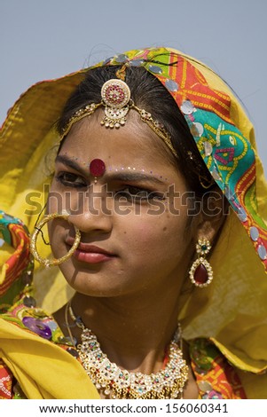 PUSHKAR, INDIA - NOVEMBER 21: An unidentified girl attends the Pushkar fair on November 21, 2012 in Pushkar, Rajasthan, India. Pilgrims and camel traders flock to the holy town for the annual fair.