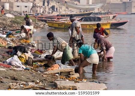 VARANASI, INDIA - DECEMBER 1: Unidentified Indian people wash clothes in Ganga river on  December 1, 2012 in Varanasi, India. For many dwellers of Varanasi the Ganga is only way to wash clothes.